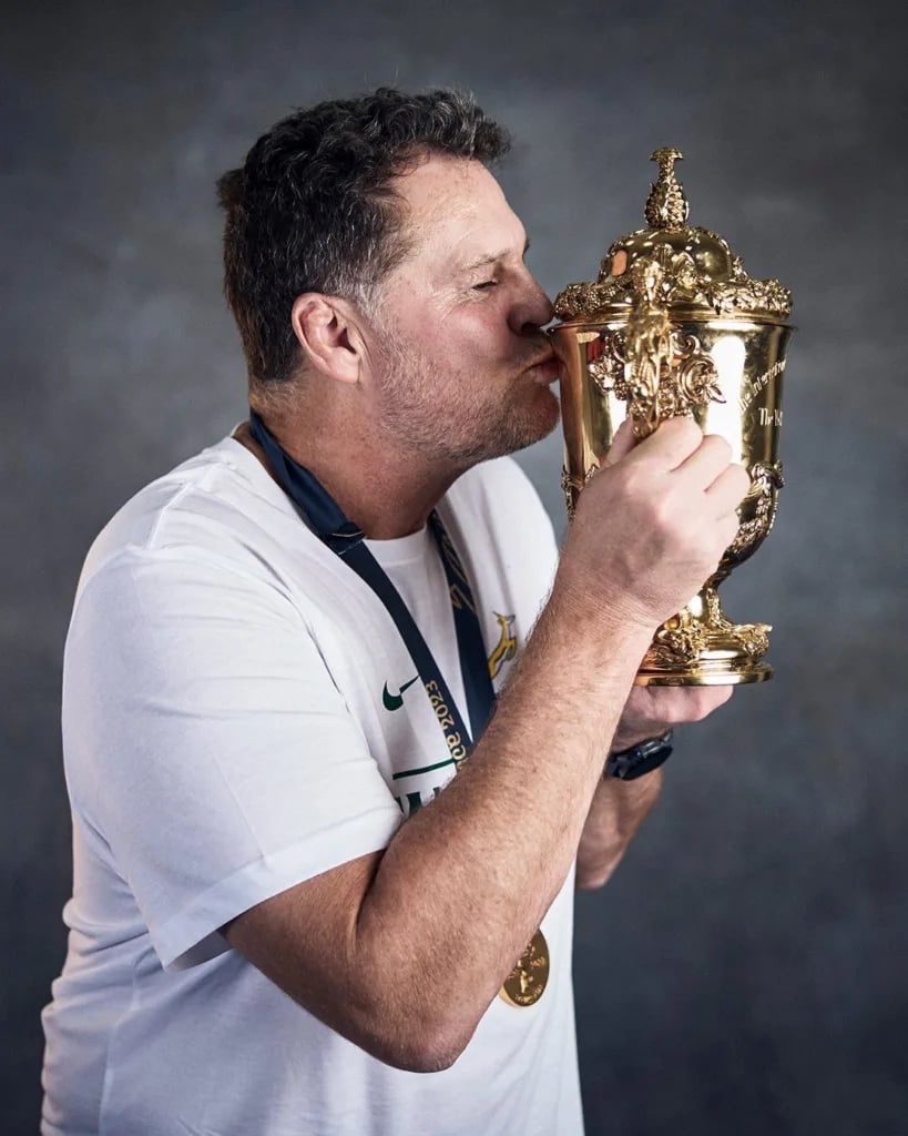 Rassie Erasmus directing the Springboks as head coach kissing World Cup trophy