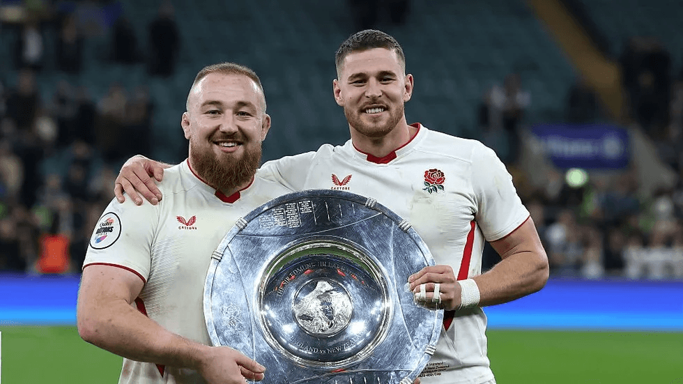 Joe Heyes celebrates England victory holding silverware, highlighting his improved form and Cheika’s influence on his development