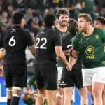 Springboks and All Blacks players shake hands on the pitch after the final whistle of a Test match