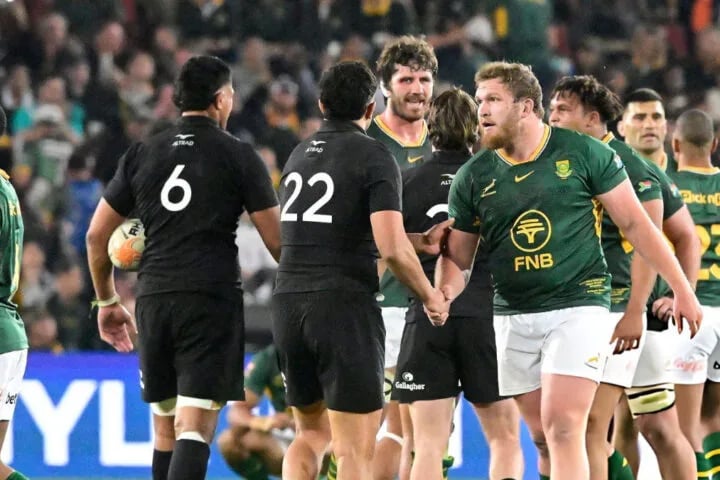 Springboks and All Blacks players shake hands on the pitch after the final whistle of a Test match