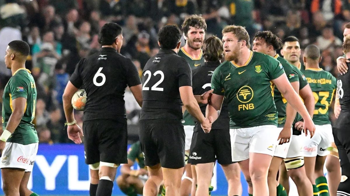 Springboks and All Blacks players shake hands on the pitch after the final whistle of a Test match