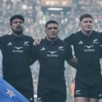 He was 63 years old, standing on the Ellis Park grass with the New Zealand flag in his hands and no real idea where he was meant to put himself. The anthems were about to start. Sixty-two thousand people were waiting. And the former All Blacks captain was, by his own account, stuck. Then Ardie Savea put an arm around him and pulled him into the line.