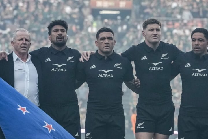 He was 63 years old, standing on the Ellis Park grass with the New Zealand flag in his hands and no real idea where he was meant to put himself. The anthems were about to start. Sixty-two thousand people were waiting. And the former All Blacks captain was, by his own account, stuck. Then Ardie Savea put an arm around him and pulled him into the line.