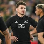 Beauden Barrett, hands on hips, among All Blacks players after a defeat to the Springboks