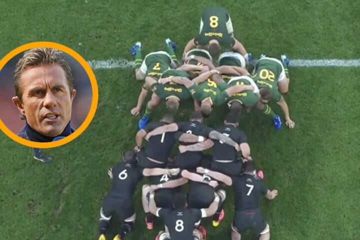 Justin Marshall in a broadcast position above a Test match, headset on, watching the field below