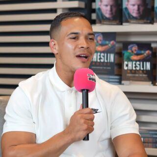 Cheslin Kolbe speaks on For The Love Of Rugby: South Africa about growing up in Scottsville, Kraaifontein, with copies of his book behind him
