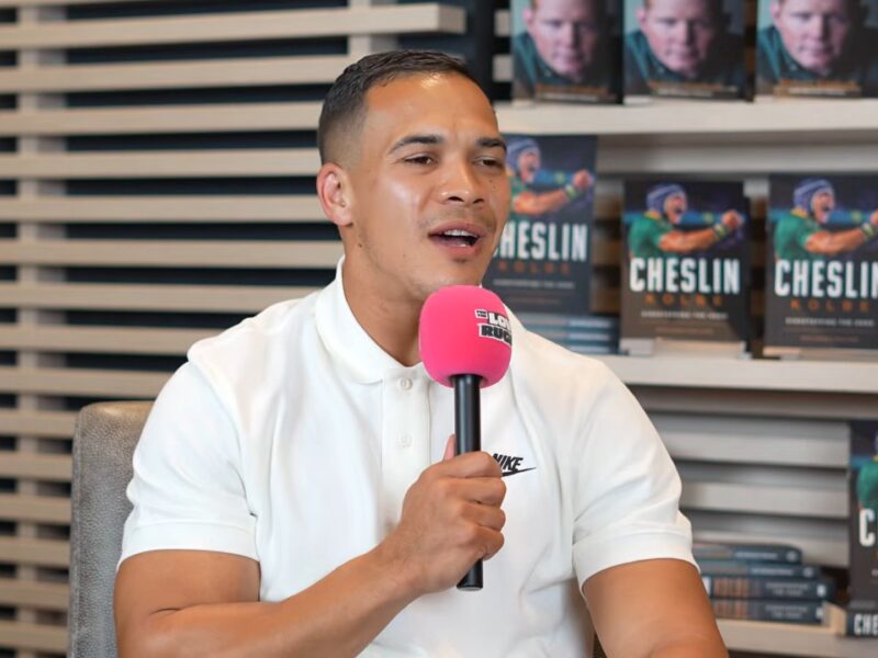 Cheslin Kolbe speaks on For The Love Of Rugby: South Africa about growing up in Scottsville, Kraaifontein, with copies of his book behind him
