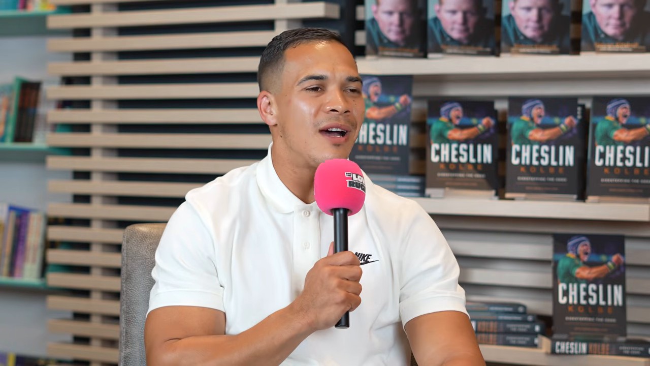 Cheslin Kolbe speaks on For The Love Of Rugby: South Africa about growing up in Scottsville, Kraaifontein, with copies of his book behind him