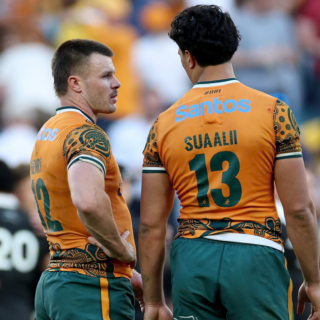 Wallabies player ratings vs All Blacks: Joseph-Aukuso Suaalii in the gold 13 shirt stands beside the Wallabies 12, with an All Black behind them