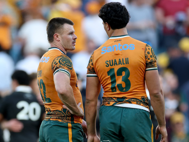 Wallabies player ratings vs All Blacks: Joseph-Aukuso Suaalii in the gold 13 shirt stands beside the Wallabies 12, with an All Black behind them
